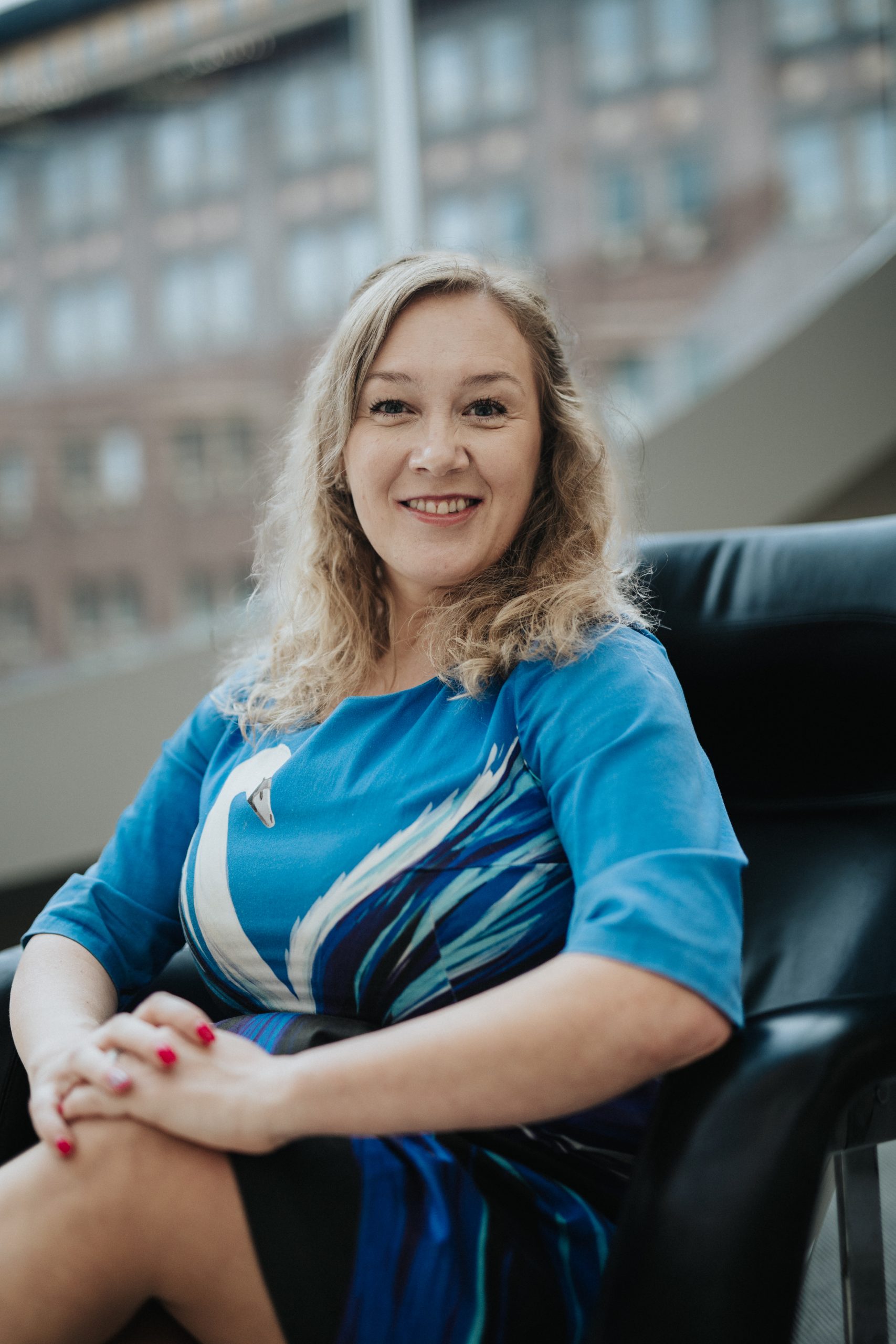 Woman sitting on a chair, smiling