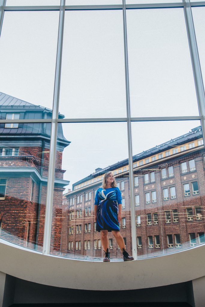 Woman standing infront of a big window